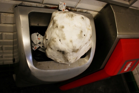 A ball of snow on the trash can