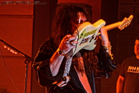 Yngwie Malmsteen playing guitar with his teeth